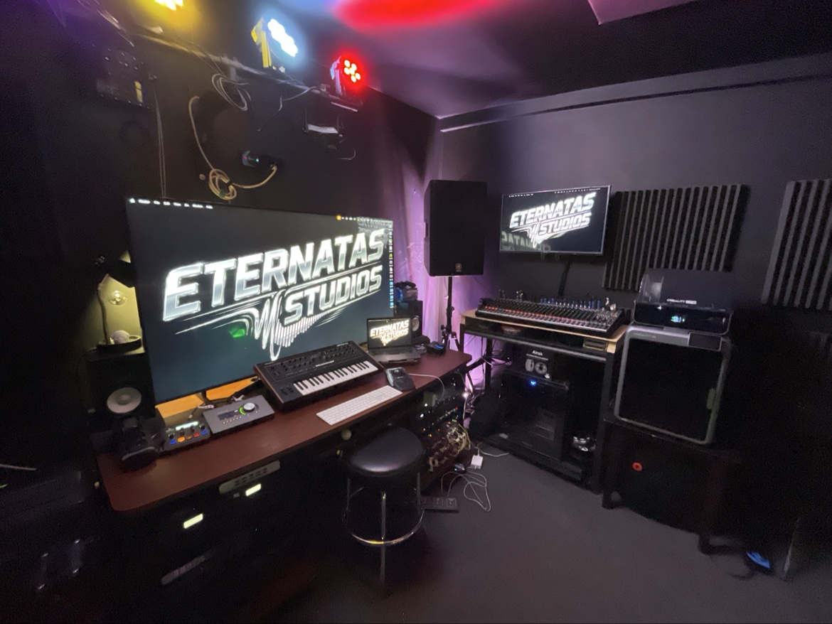The Eternatas Studios logo across the room's screens, DMX fixtures glowing across the ceiling